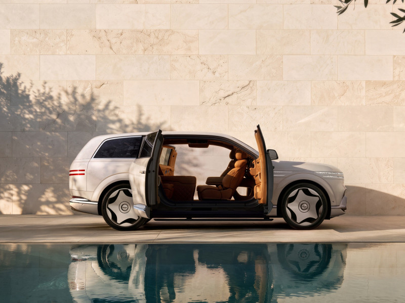Genesis GV90 Neolun side view with coach doors open and no B-pillar, showing the lounge interior