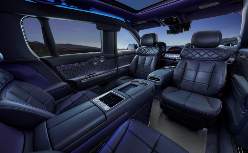 Genesis GV90 four-seat lounge interior in navy blue with the front seats swiveled to face the rear