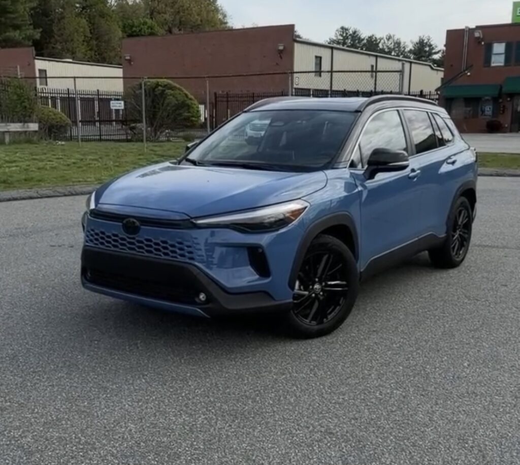 2026 Toyota Corolla Cross Hybrid XSE front three-quarter view in Cavalry Blue with blacked-out trim