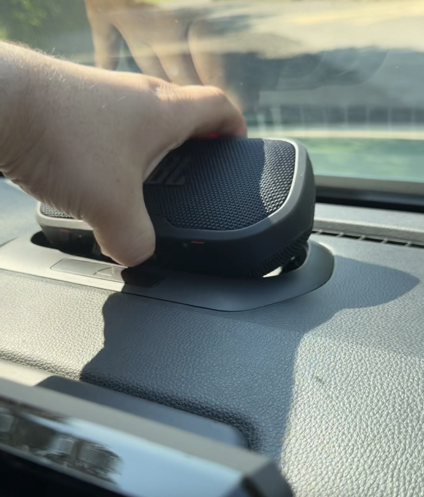 Removable JBL Bluetooth speaker being pulled from the dashboard of the 2026 Toyota 4Runner Trailhunter