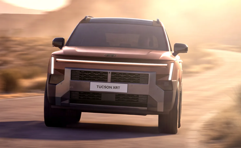 2027 Hyundai Tucson XRT front view on a dirt road with full-width lighting