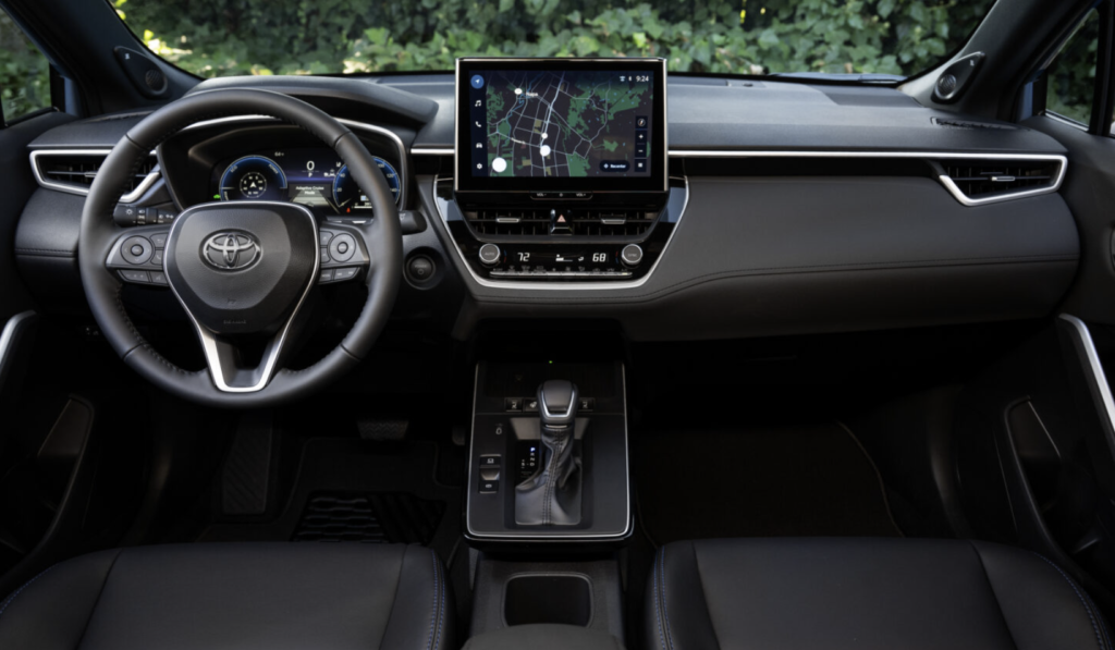 2026 Toyota Corolla Cross Hybrid interior showing the touchscreen, dashboard, and steering wheel