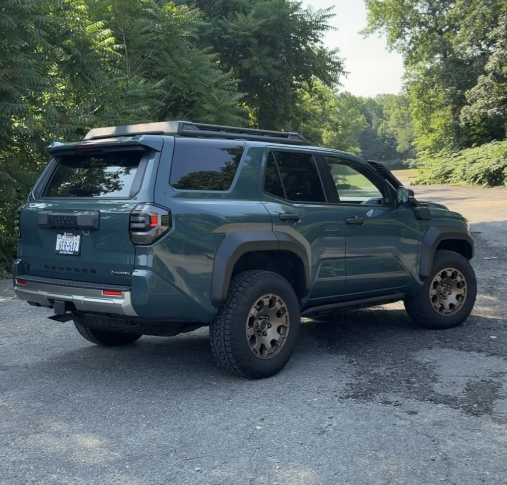 2026 Toyota 4Runner Trailhunter rear three-quarter view showing ARB roof rack and bronze 18-inch wheels