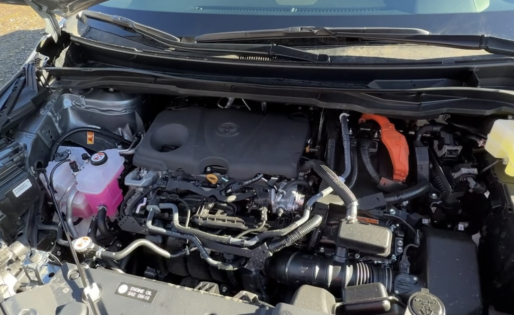 2.5L four-cylinder hybrid engine bay of the 2025 Toyota Sienna with the orange high-voltage cabling visible