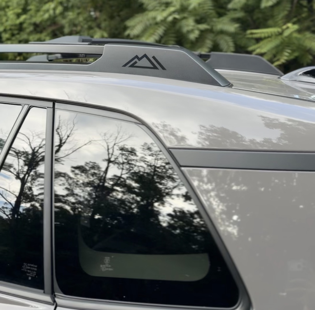 Woodland mountain logo on the black roof rail cross bar of the 2026 Toyota RAV4