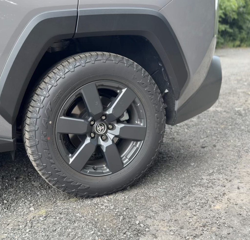 18-inch black wheel and Dunlop Grandtrek all-terrain tire on the 2026 Toyota RAV4 Woodland