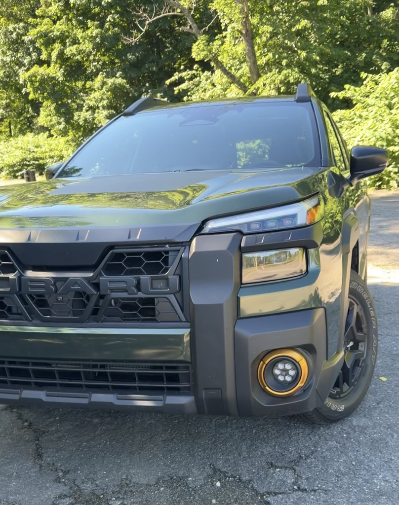 Front fascia detail of the 2026 Subaru Outback Wilderness showing the copper-ringed fog light and blacked-out grille
