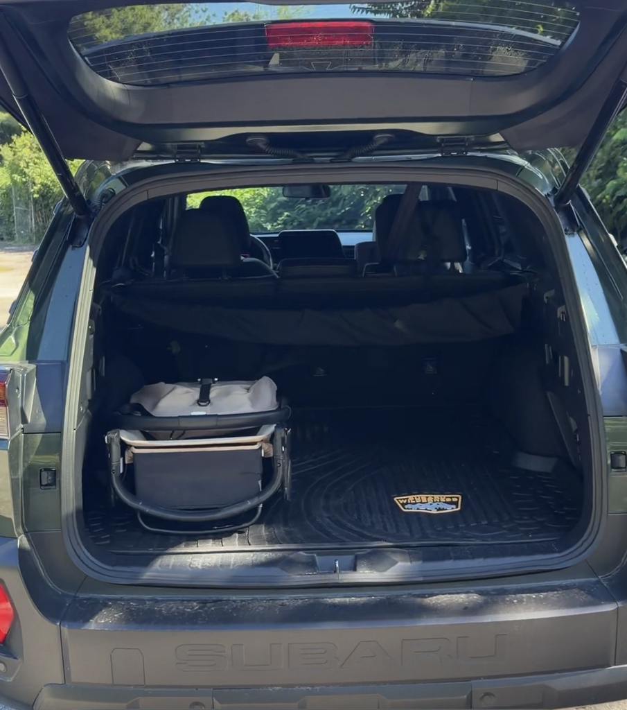 UPPAbaby Cruz stroller in the squared cargo area of the 2026 Subaru Outback Wilderness with the Wilderness logo mat