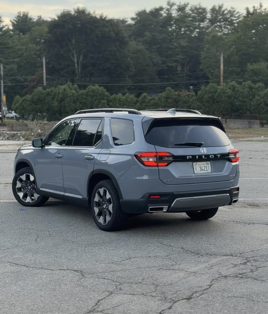 2026 Honda Pilot Elite rear three-quarter view showing the Pilot tailgate badging and roof rails