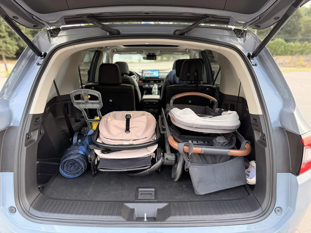 UPPAbaby Cruz stroller split into pieces to fit behind the third row of the 2026 Honda Pilot