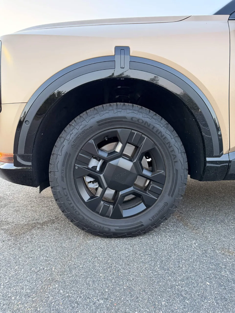Four-spoke wheel and Continental all-terrain tire with black fender cladding on the 2027 Kia Telluride X-Pro