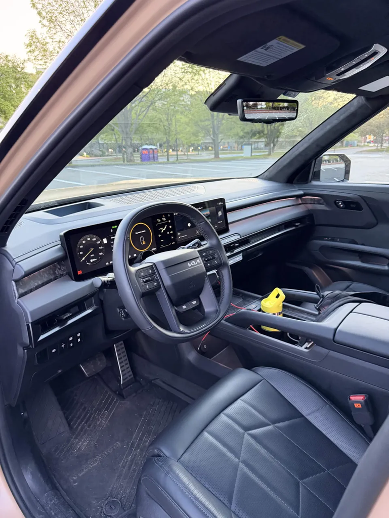 2027 Kia Telluride X-Pro interior showing the panoramic display, squared steering wheel, and quilted leather seats