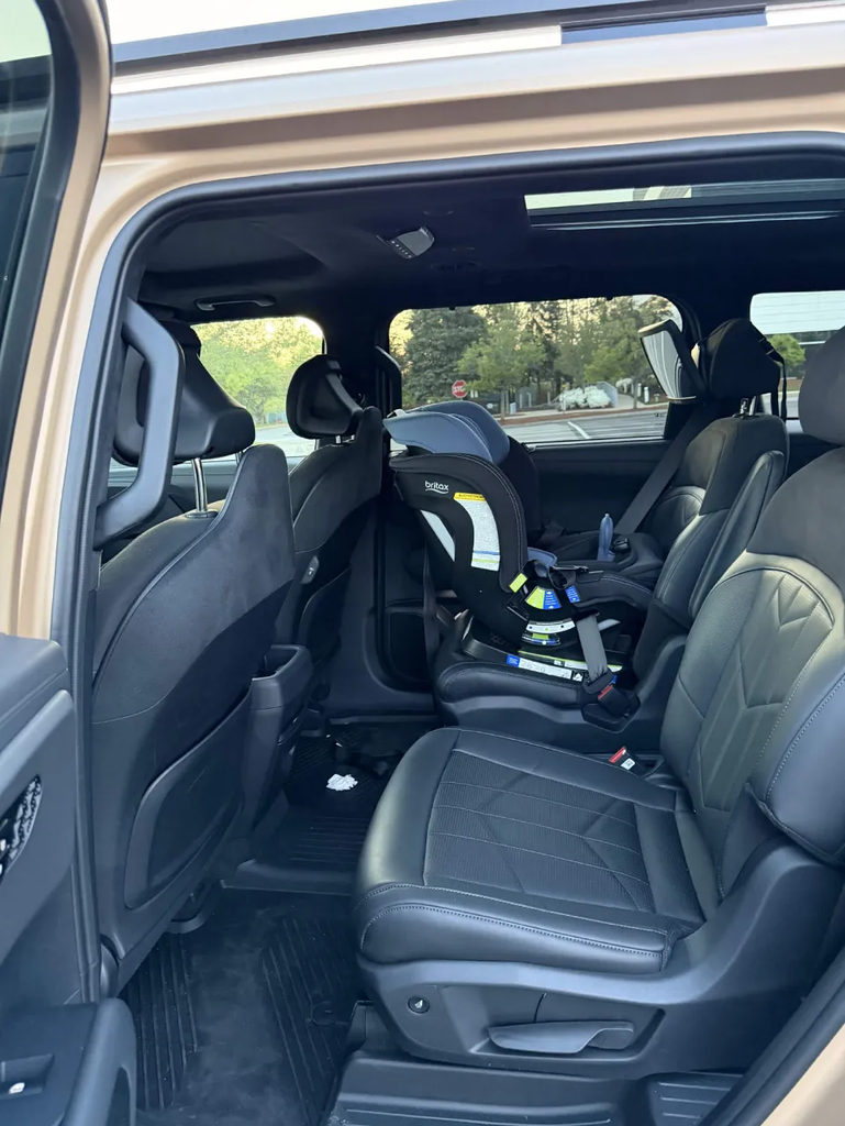 Britax car seat installed on the second-row captain\u0027s chair of the 2027 Kia Telluride through the wide door opening