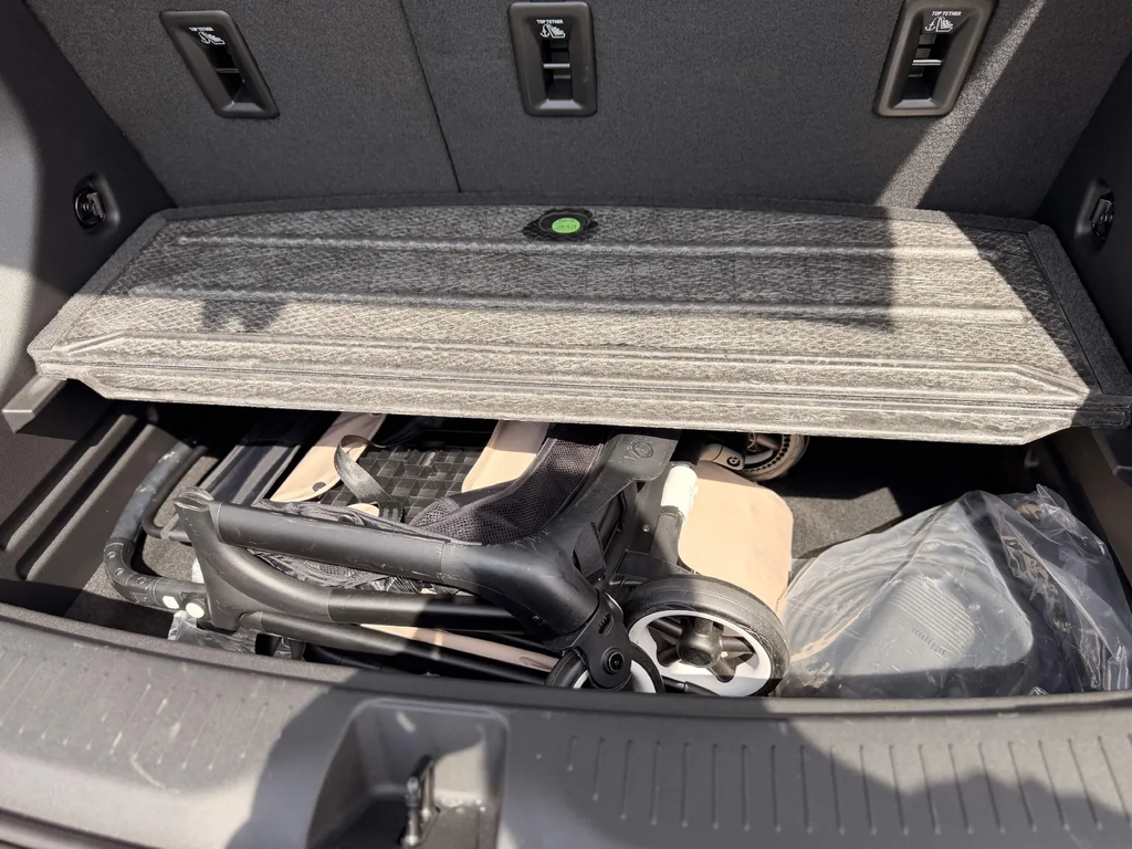 Bugaboo Butterfly stroller stored underneath the load floor of the 2027 Chevrolet Bolt trunk