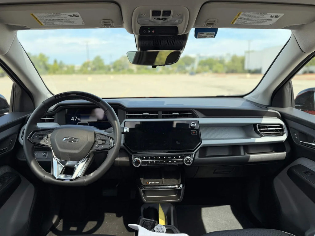 2027 Chevrolet Bolt RS interior showing the 11.3-inch touchscreen, digital cluster, and physical climate controls