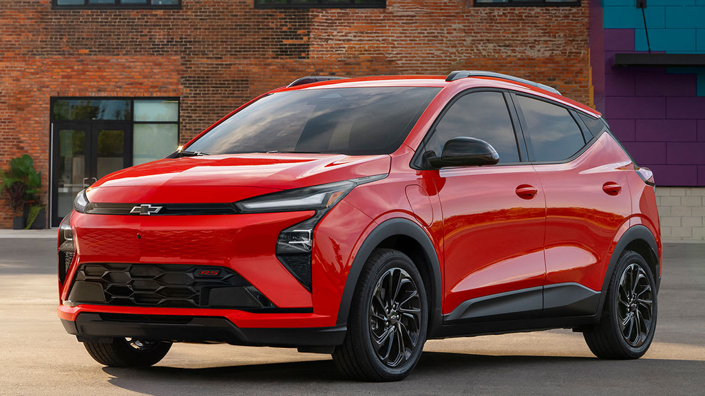 2027 Chevrolet Bolt RS press photo in red against a brick building