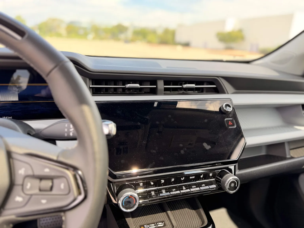 Center screen angle and climate knobs of the 2027 Chevrolet Bolt with the volume knob on the far side of the display