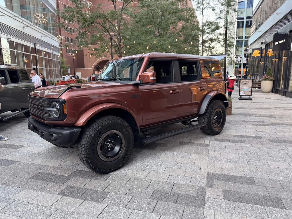 Ford Bronco Filson First Edition in Iron Sands Copper Metallic parked in Boston Seaport with a second Bronco Filson behind it
