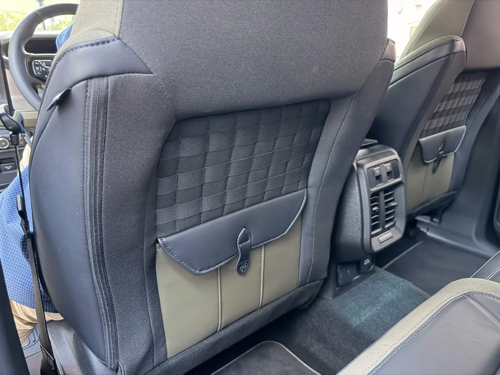 Filson seatback bag with leather flap and buckle replacing the map pocket inside the Ford Bronco Filson