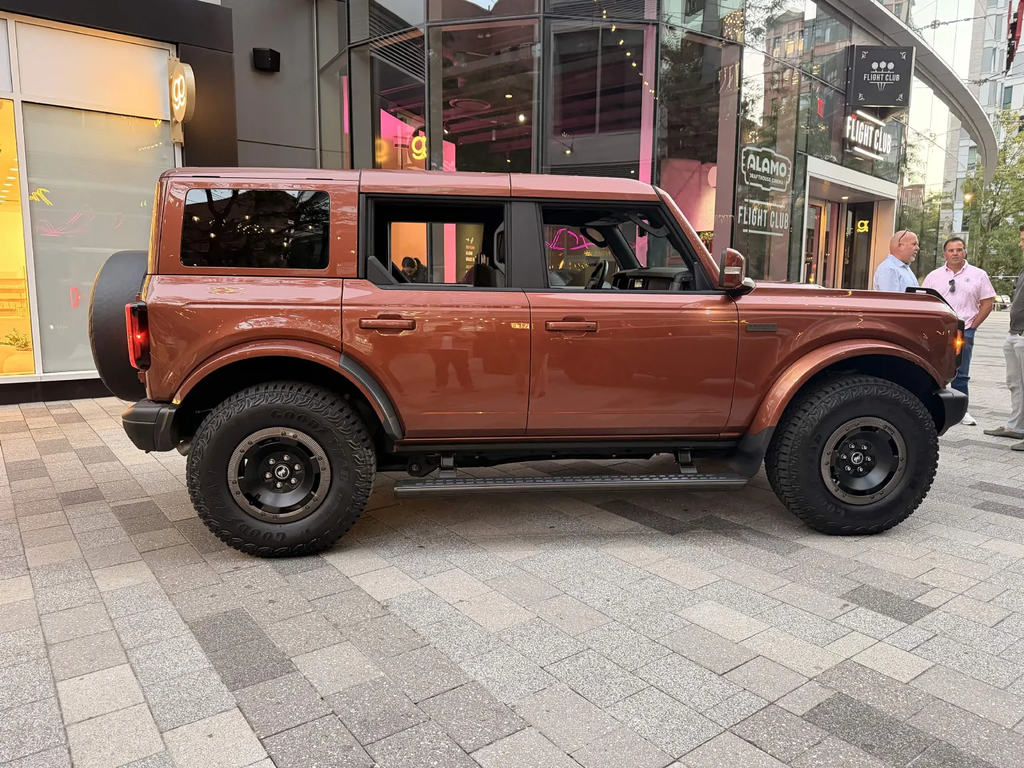 Side profile of the Bronco Filson First Edition in Iron Sands Copper Metallic on 35-inch tires in Boston Seaport