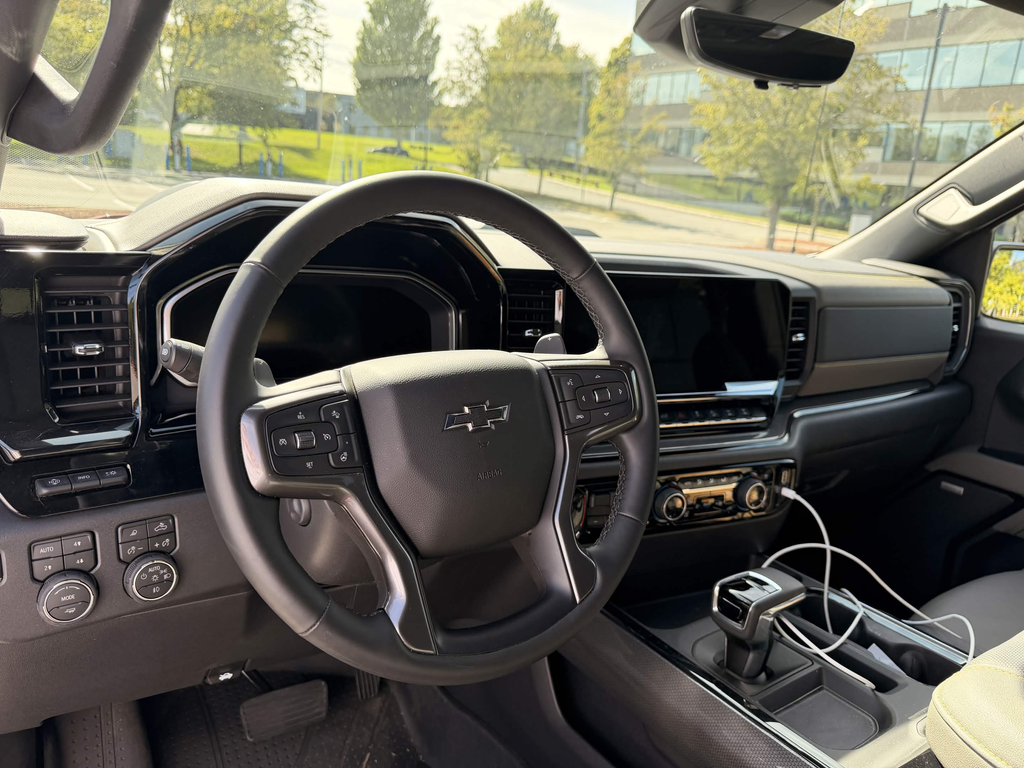 2026 Chevrolet Silverado ZR2 interior showing the integrated dash screens, steering wheel, and physical climate buttons