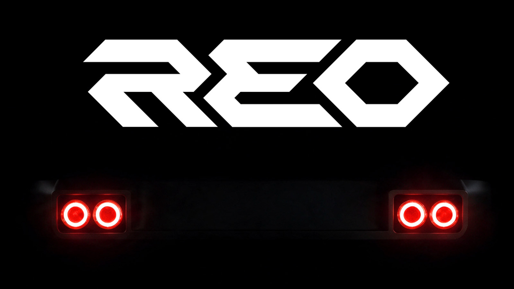 REO teaser showing the logo above four round LED taillights glowing red in the dark
