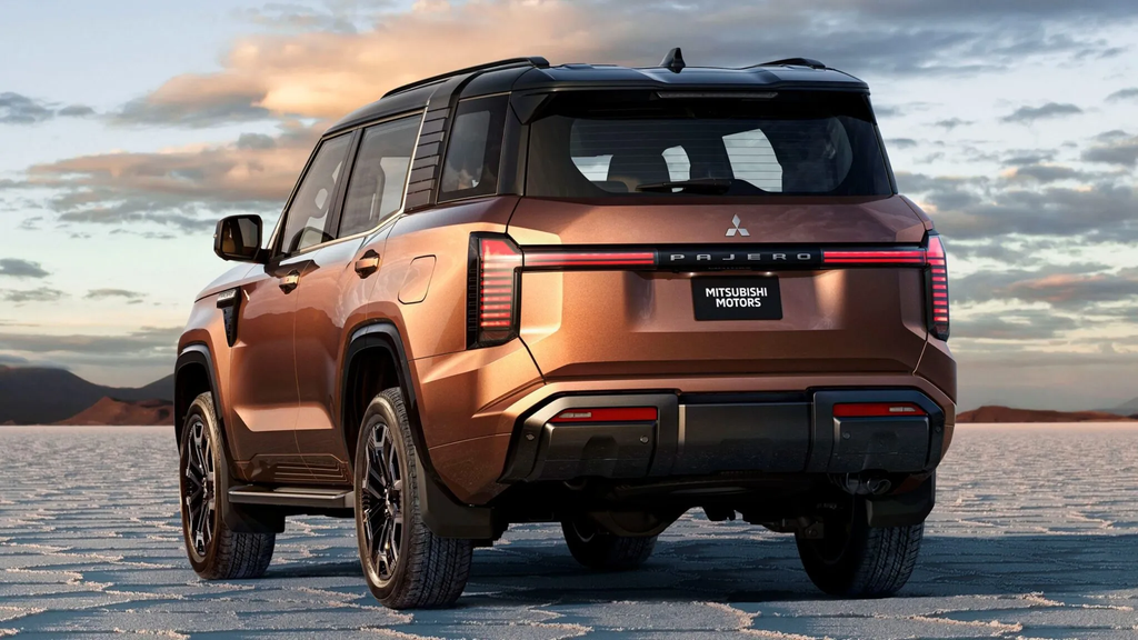 2027 Mitsubishi Pajero rear view in bronze on a salt flat showing the clean tailgate and full-width light bar