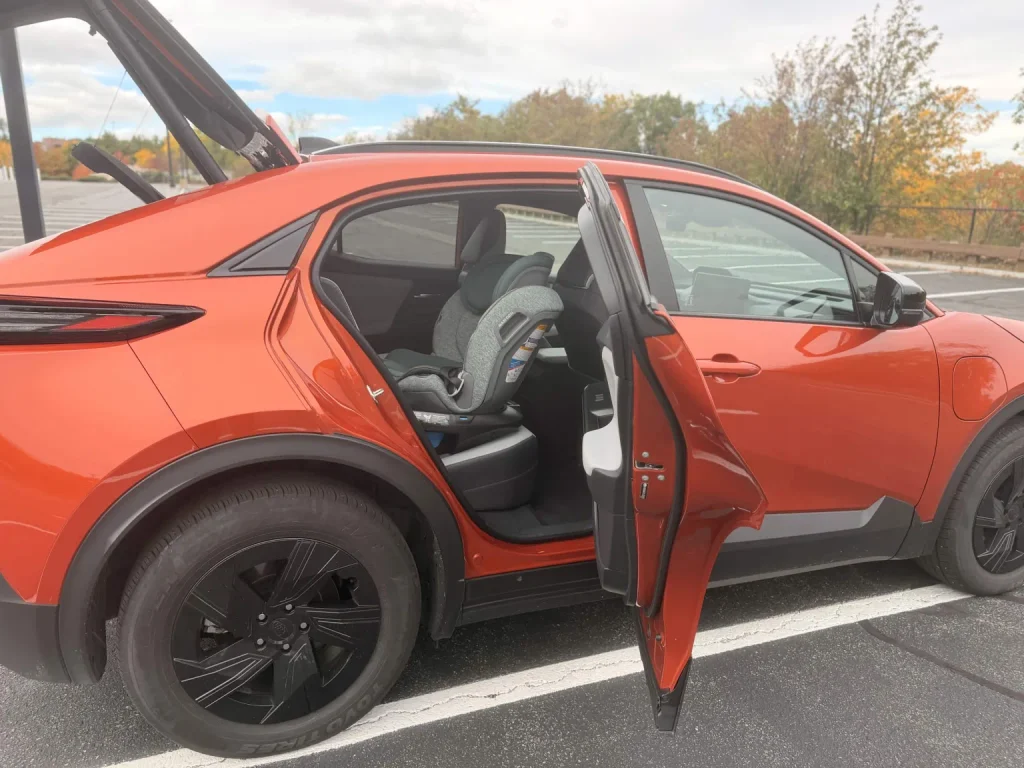 2026 Subaru Uncharted rear door open showing a child car seat in the back seat