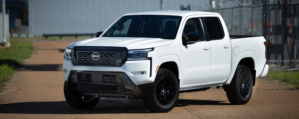 Nissan Frontier in white with black wheels, front three-quarter view