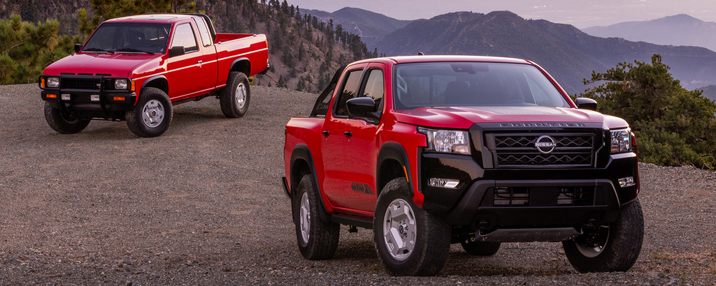 Classic Nissan Hardbody pickup parked beside the modern Nissan Frontier