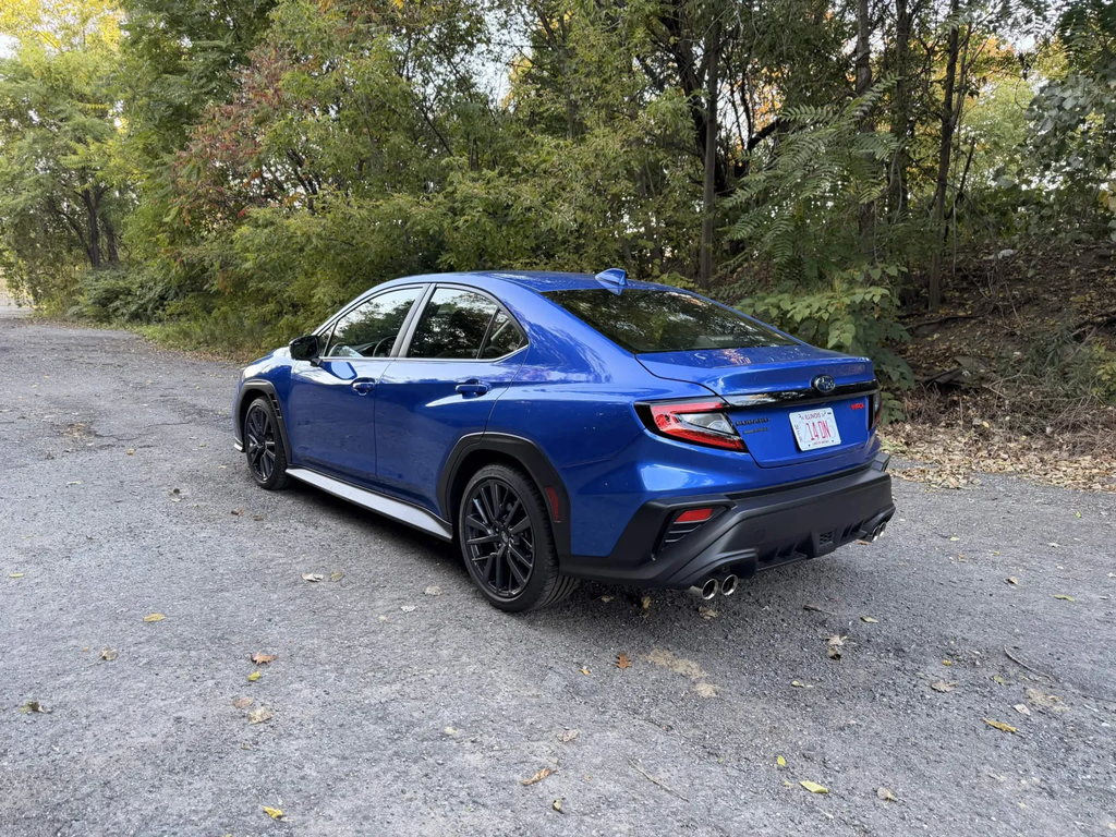 2026 Subaru WRX base rear three quarter view in WR Blue Pearl on a gravel road