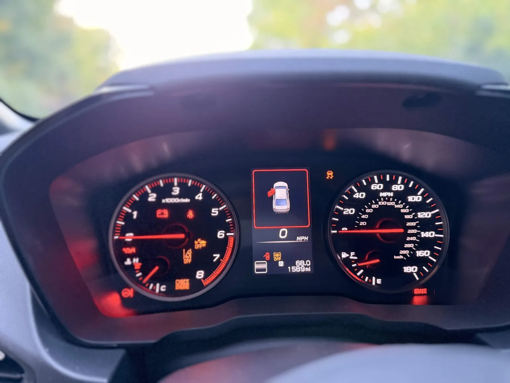 2026 Subaru WRX analog gauge cluster seen through the steering wheel